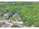 Aerial view of a cleared parcel showing the homesite, surrounded by mature trees and a road at 8828 Jasmine Blvd, Port Richey, FL 34668