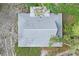 The rectangular roof is showcased in this aerial view, accented by surrounding trees and landscaping at 8828 Jasmine Blvd, Port Richey, FL 34668
