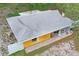 Aerial view showcases roof and exterior, including a porch and fenced yard for outdoor enjoyment at 8828 Jasmine Blvd, Port Richey, FL 34668