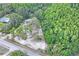 Expansive aerial view of a parcel showing the mature trees, sandy clearing, and road frontage at 8828 Jasmine Blvd, Port Richey, FL 34668