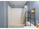 A clean, functional bathroom featuring a shower-tub combination with a gray striped shower curtain at 8828 Jasmine Blvd, Port Richey, FL 34668