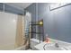 Bathroom features a bathtub and shower combination with gray painted walls at 8828 Jasmine Blvd, Port Richey, FL 34668