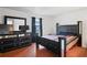 Bedroom with a queen bed, modern furnishings and brick floors at 8828 Jasmine Blvd, Port Richey, FL 34668