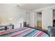 Bedroom featuring open closet, bed and decor at 8828 Jasmine Blvd, Port Richey, FL 34668