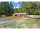 Charming one-story home featuring a fenced yard and inviting front porch at 8828 Jasmine Blvd, Port Richey, FL 34668