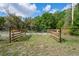 Gated parcel entry with sturdy fencing and ample space, offering privacy and security at 8828 Jasmine Blvd, Port Richey, FL 34668