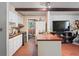 Kitchen with white cabinetry, vintage appliances, and breakfast bar, open to living area at 8828 Jasmine Blvd, Port Richey, FL 34668