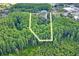 Aerial view highlighting approximate outline of the lot surrounded by dense trees, ensuring privacy at 8828 Jasmine Blvd, Port Richey, FL 34668