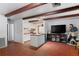 Open concept living room, adjacent to kitchen, with brick floors and decor at 8828 Jasmine Blvd, Port Richey, FL 34668
