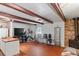 Living room with beamed ceiling, brick flooring, brick fireplace and modern decor at 8828 Jasmine Blvd, Port Richey, FL 34668