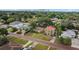 Aerial view of property showing neighborhood street and surrounding houses and mature trees at 910 W Virginia Ave, Tampa, FL 33603