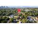 An aerial view of a neighborhood with mature trees and a body of water in the background at 910 W Virginia Ave, Tampa, FL 33603