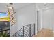 Hallway with modern chandelier and staircase view showcases the home's contemporary design elements at 910 W Virginia Ave, Tampa, FL 33603