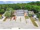 Aerial view of townhomes with mature trees, driveways, and a vibrant tree canopy backdrop at 9473 N Forest Hills Pl, Tampa, FL 33612