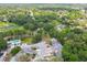 Aerial view of a neighborhood featuring mature trees, green spaces, and swimming pool at 9473 N Forest Hills Pl, Tampa, FL 33612