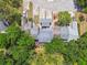 Houses nestled within lush trees with paved driveways at 9473 N Forest Hills Pl, Tampa, FL 33612