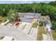 Aerial shot shows the layout of three houses with double car garages and lush landscaping at 9473 N Forest Hills Pl, Tampa, FL 33612