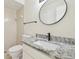 Bathroom featuring modern vanity with granite countertop and a tiled shower at 9473 N Forest Hills Pl, Tampa, FL 33612