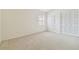 Neutral carpeted bedroom features folding-door closet and a window at 9473 N Forest Hills Pl, Tampa, FL 33612