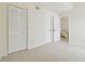 Bedroom featuring carpeted floors, closet, and access to stairs at 9473 N Forest Hills Pl, Tampa, FL 33612
