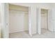 Walk-in closet featuring multiple folding doors with adjustable shelving at 9473 N Forest Hills Pl, Tampa, FL 33612