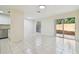 Open dining area with tile flooring, a window, and sliding door access to the patio at 9473 N Forest Hills Pl, Tampa, FL 33612
