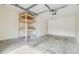 Spacious garage with added shelving for storage and sealed concrete floors at 9473 N Forest Hills Pl, Tampa, FL 33612