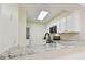 Bright kitchen features granite countertops, white cabinets, and stainless steel appliances at 9473 N Forest Hills Pl, Tampa, FL 33612