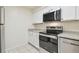Kitchen with stainless steel appliances, granite countertops, and white cabinets at 9473 N Forest Hills Pl, Tampa, FL 33612