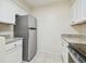Kitchen with stainless steel refrigerator and white cabinets at 9473 N Forest Hills Pl, Tampa, FL 33612