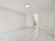 Large living room with neutral tile flooring and a view of the staircase at 9473 N Forest Hills Pl, Tampa, FL 33612