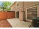 A private outdoor patio features a sliding door to the home's interior and a wood fence at 9473 N Forest Hills Pl, Tampa, FL 33612