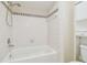 Shower and tub combination featuring white tiling and trim at 9473 N Forest Hills Pl, Tampa, FL 33612