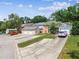 Homes with double car garages and lush landscaping on quiet street at 9473 N Forest Hills Pl, Tampa, FL 33612