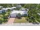 Aerial view of a well-maintained single-story home with a charming front yard and driveway at 9690 41St N St # 0, Pinellas Park, FL 33782
