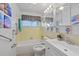Bathroom with a tub and shower combo, tile walls, and a window for natural light at 9690 41St N St # 0, Pinellas Park, FL 33782