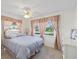 Comfortable bedroom with neutral decor, natural light, and a ceiling fan at 9690 41St N St # 0, Pinellas Park, FL 33782