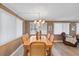Bright dining area showcasing a wooden dining table, large windows, and a comfortable living space nearby at 9690 41St N St # 0, Pinellas Park, FL 33782