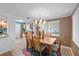 Charming dining space with a wooden table, stylish chandelier, and a view into the adjacent kitchen at 9690 41St N St # 0, Pinellas Park, FL 33782