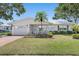 Single-story home with a well-kept lawn, front porch, and attached garage at 9690 41St N St # 0, Pinellas Park, FL 33782