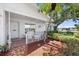 Charming front porch with cozy seating, lush greenery, and welcoming entrance at 9690 41St N St # 0, Pinellas Park, FL 33782