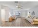Open-concept living room featuring wood flooring, ceiling fan and natural light at 9690 41St N St # 0, Pinellas Park, FL 33782