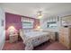 Cozy main bedroom with purple accent wall, soft carpet, and ample natural light at 9690 41St N St # 0, Pinellas Park, FL 33782