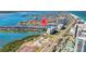 Aerial view of townhome community along canal with tennis courts, parking, and water views at 101 Marina Del Rey Ct, Clearwater, FL 33767