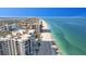 Breathtaking aerial view of beachfront condos with pristine sandy beach and clear blue ocean waters at 101 Marina Del Rey Ct, Clearwater, FL 33767