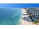 Beautiful aerial view of pristine beach with luxury condos and turquoise waters, sunny skies at 101 Marina Del Rey Ct, Clearwater, FL 33767