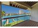 Balcony view featuring a waterway, boat docks, lush greenery, and high-rise buildings under a clear blue sky at 101 Marina Del Rey Ct, Clearwater, FL 33767