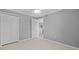 Spacious bedroom with tile floors, white trim, and a view into the hallway and kitchen at 101 Marina Del Rey Ct, Clearwater, FL 33767