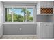 Bright breakfast nook with a built-in wine rack and a large window with palm tree views at 101 Marina Del Rey Ct, Clearwater, FL 33767