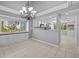 Spacious dining room with tile floors, elegant chandelier, and views of the neighborhood at 101 Marina Del Rey Ct, Clearwater, FL 33767